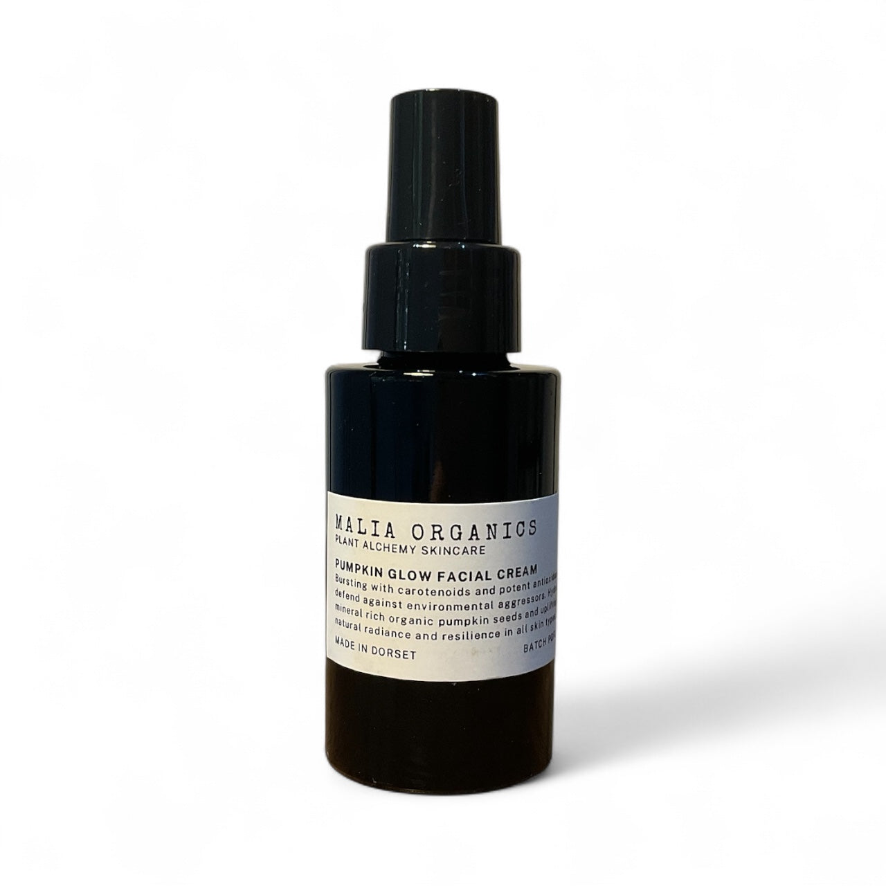 Black bottle with a label on a white background pumpkin glow face cream